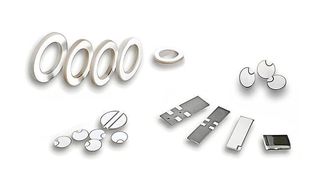 Various piezoceramic products and components for the automotive sector on a white background